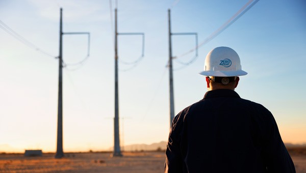 GridLiance engineer by the transmission poles