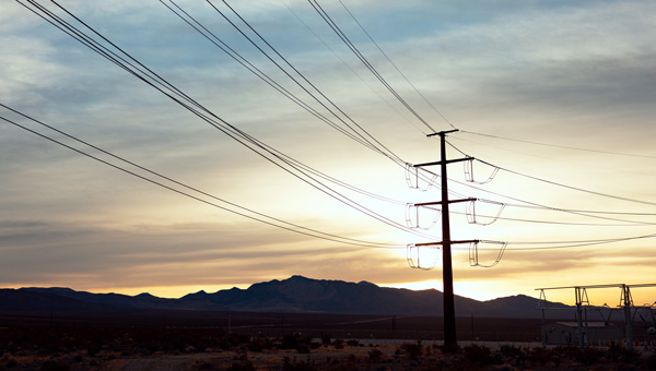 Sunrise behind a GridLiance transmission line