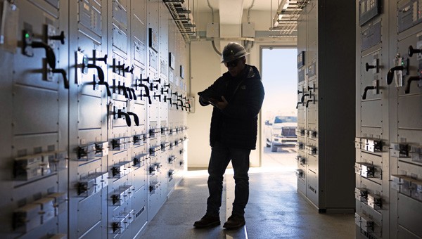 Engineer working inside a transmission substation
