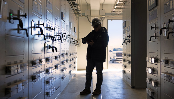 Engineer working inside a transmission substation